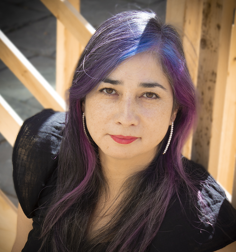 A photo of Angela Misri wearing a black top.