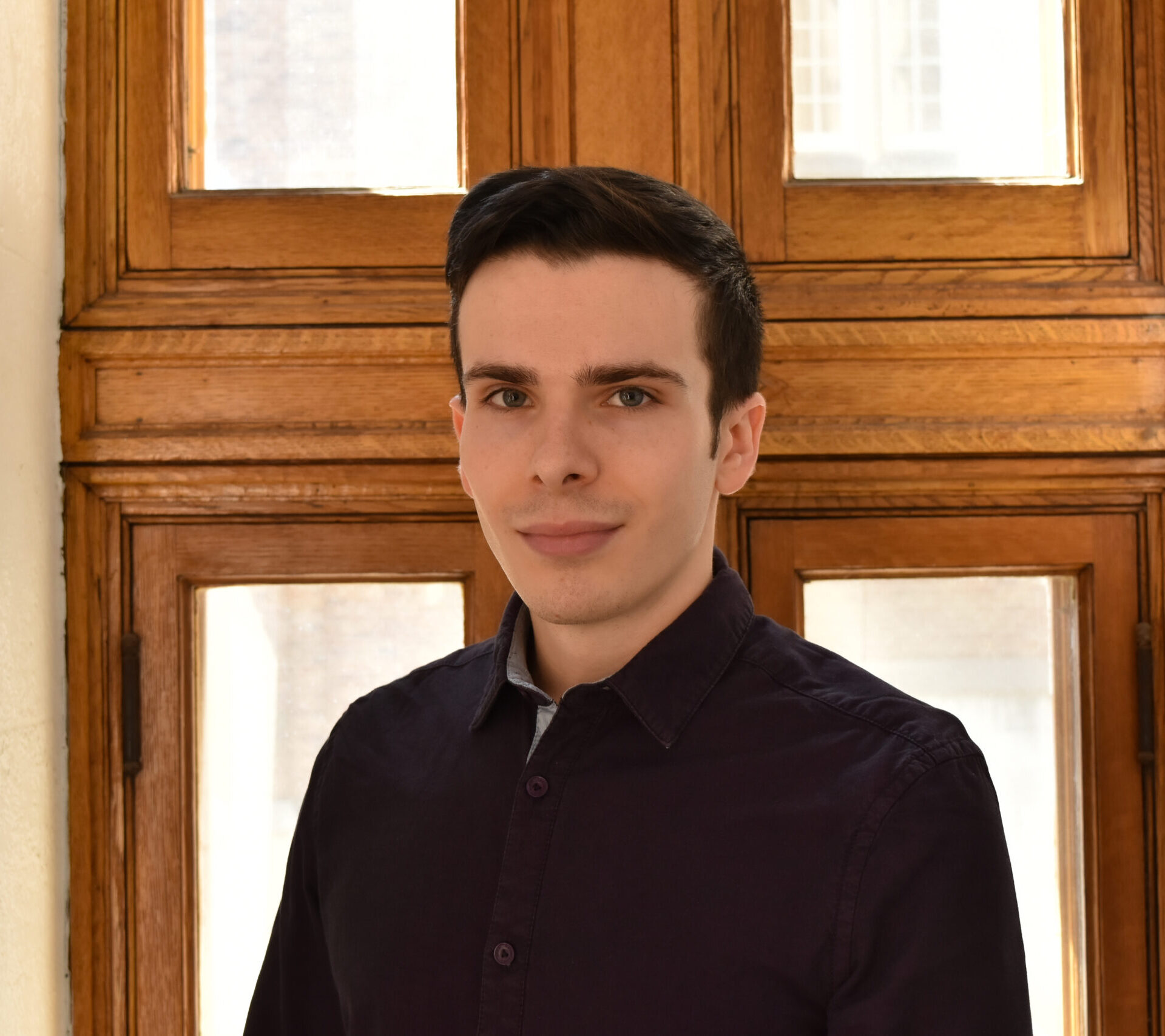 A photo of Clement Lechat wearing a black top.