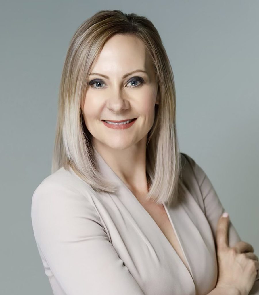 A photo of Lisa Sygutek wearing a tan top.